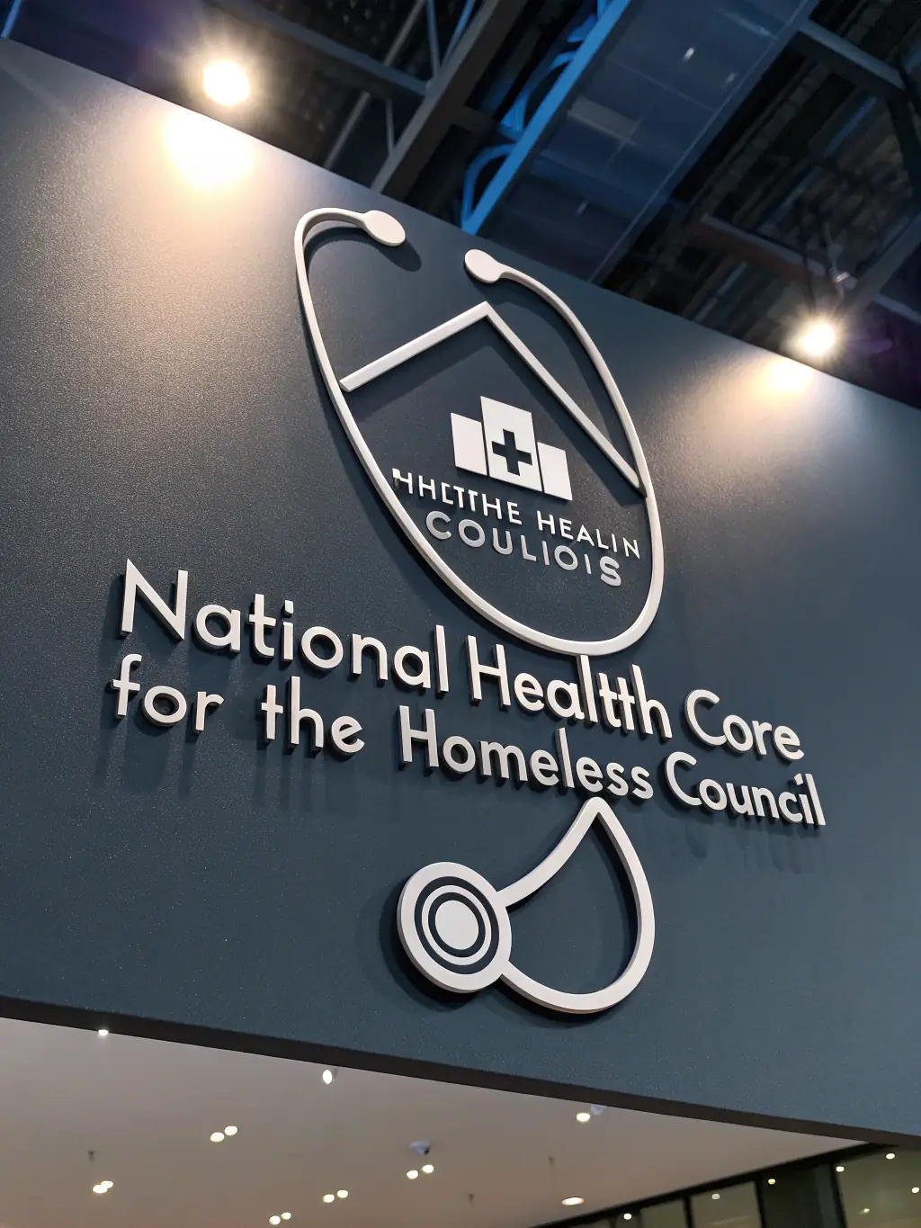 A photograph of the National Health Care for the Homeless Council logo, an organization advocating for healthcare access for homeless individuals.